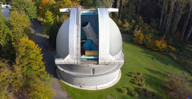 The Perek Telescope in Ondřejov. A very large building with a partially open dome.