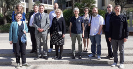 A group of people on the stairs in front of a builing.