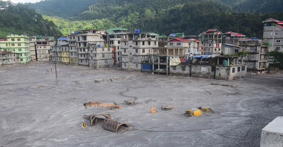 Buildings and cars in the town of Rangpo were buried under the sediment masses of the flood.